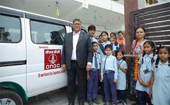 The children with the school van donated by ONGC
